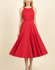 Woman wearing a red dress on a beige background
