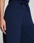 Navy blue pants with a tie waist on a light gray background