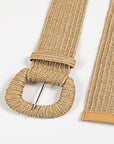 Beige woven belt with a metal buckle on a white background