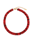 A beaded collar necklace made of alternating glossy red and deep burgundy beads, finished with a gold-tone lobster clasp and extender chain.