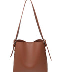 Brown leather handbag with a shoulder strap on a white background