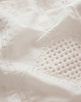 Close-up of a textured white fabric with intricate patterns