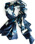Blue and white patterned scarf on a white background