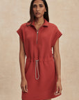 Woman wearing a red dress with a zipper on a beige background