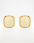 Gold square earrings on a white background