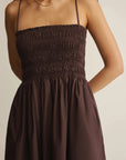 Brown dress worn by a person on a plain background