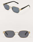 Pair of sunglasses with gold frames and black lenses on a white background