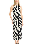 Woman wearing a black and white patterned dress on a white background
