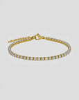 Gold bracelet with clear gemstones on a white background