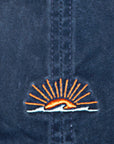 Embroidered logo on a blue denim shirt