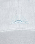 Close-up of a light blue embroidered design on a textured white fabric background