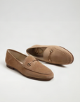 Pair of brown loafers with decorative buckles on a white background