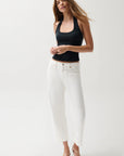 Woman wearing a black tank top and white jeans on a white background