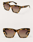Tortoiseshell sunglasses with brown gradient lenses on a white background