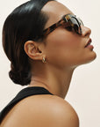 Woman wearing sunglasses with a plain background