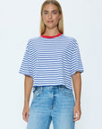 Woman wearing a striped shirt and jeans on a white background
