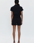 Person wearing a black outfit on a white background