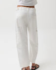 Person wearing white pants and a white shirt on a white background