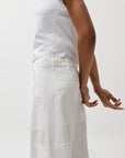 Person wearing a white outfit on a plain background