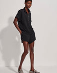 Person wearing a black outfit with a white background