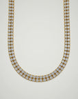 Gold necklace with diamonds on a white background