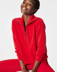 Person wearing a red tracksuit on a white background