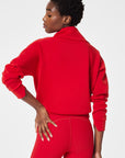 Person wearing a red tracksuit on a white background