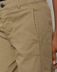 Close-up of beige pants with a neutral background