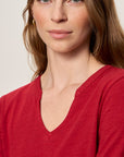 Woman wearing a red shirt against a plain background