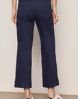 Navy blue pants worn by a person on a plain background