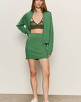 Woman wearing a green outfit with a white background