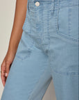 Light blue jeans worn by a person on a neutral background