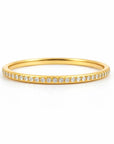 Gold ring with small diamonds on a white background