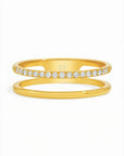 Two gold rings with diamond accents on a white background
