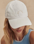 Person wearing a light gray cap with 'WAVY' branding on a beige background