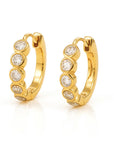 Gold hoop earrings with embedded stones on a white background