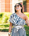 Woman wearing a black and white patterned dress outdoors.