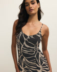 Woman wearing a zebra print dress against a plain background