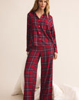 Woman wearing red plaid pajamas on a white background