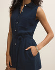 Navy blue sleeveless dress worn by a person on a beige background