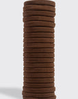 Stack of brown hair ties on a light gray background