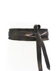Bronze-colored leather belt with a bow on a white background