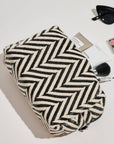 Makeup bag with makeup items on a light surface
