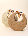 Two woven bags with ribbon straps on a beige background