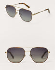 Pair of gold-framed sunglasses with gradient lenses on a white background