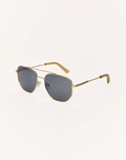 Gold-framed sunglasses with dark lenses on a white background