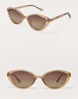 Pair of cat-eye sunglasses with gold frame and brown lenses on a white background