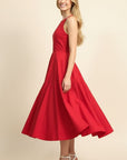 Woman wearing a red dress on a beige background