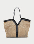 Woven handbag with black straps on a white background