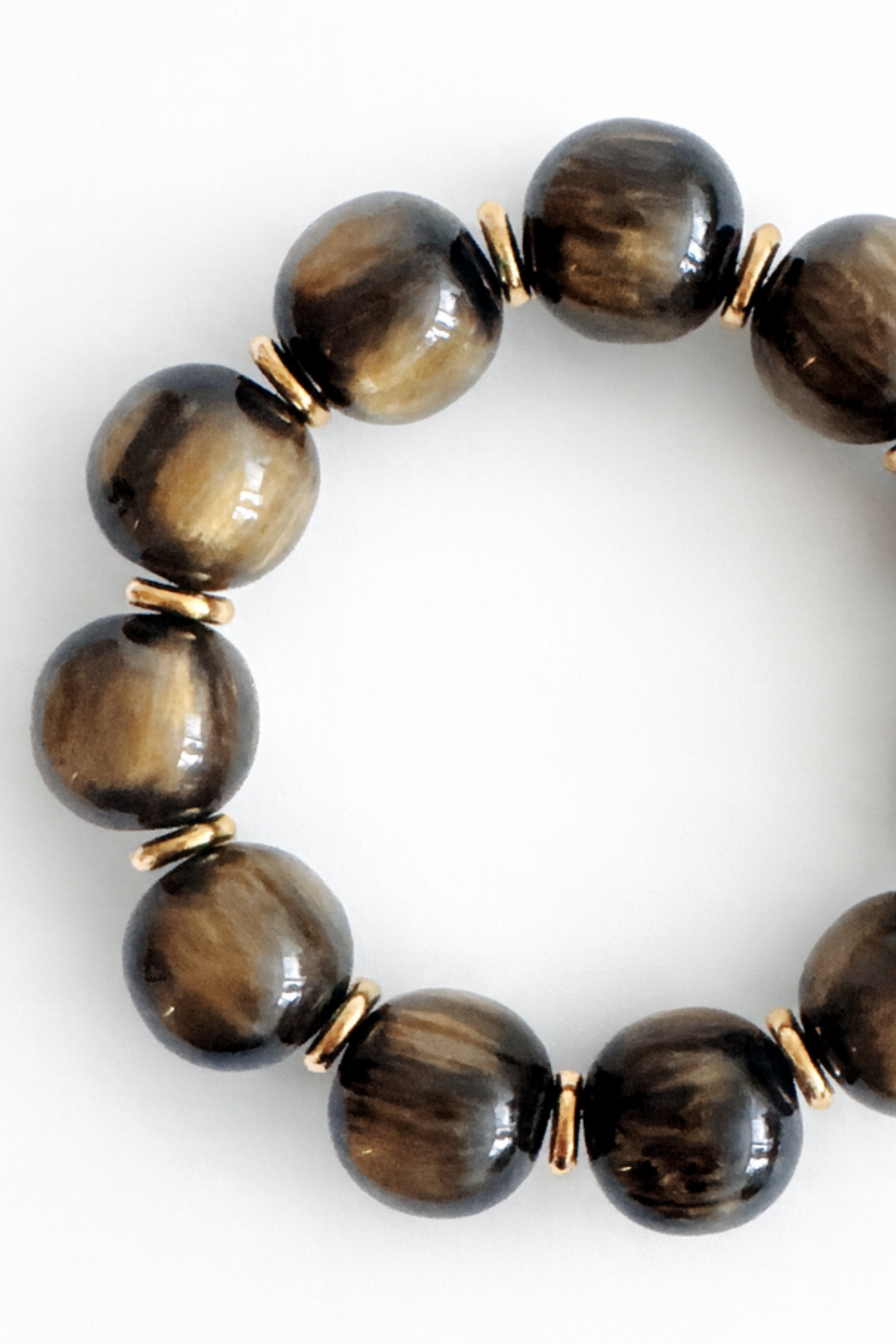 Brown beaded bracelet with gold accents on a white background